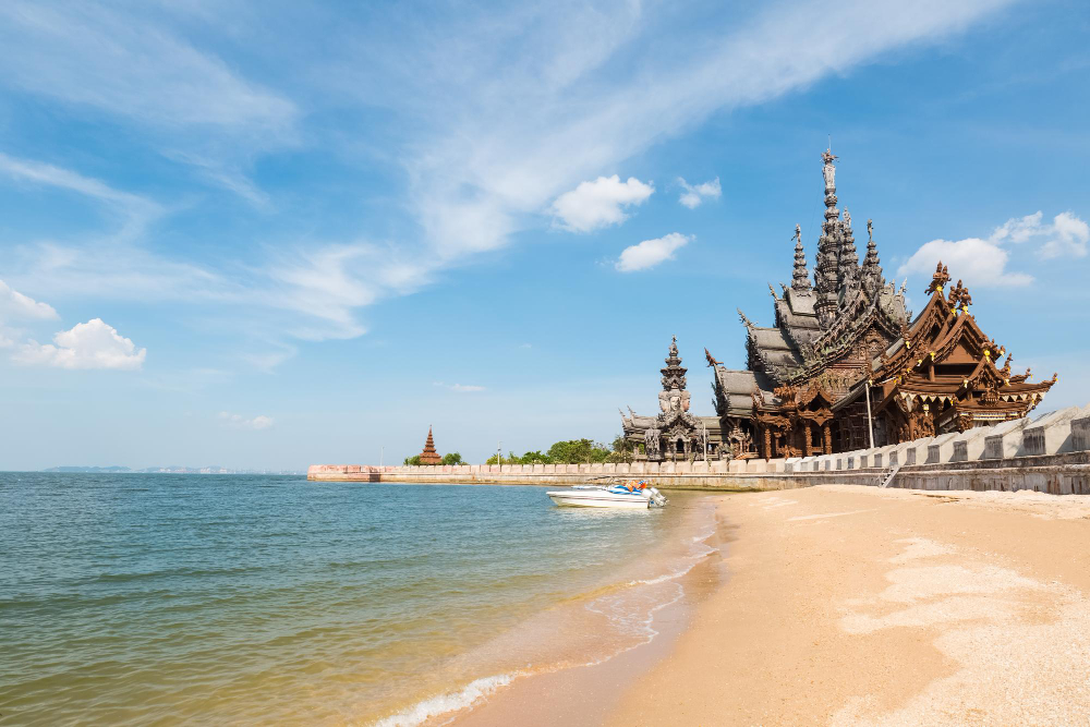 Beautiful beach in Thailand with limestone cliffs and longtail boat
