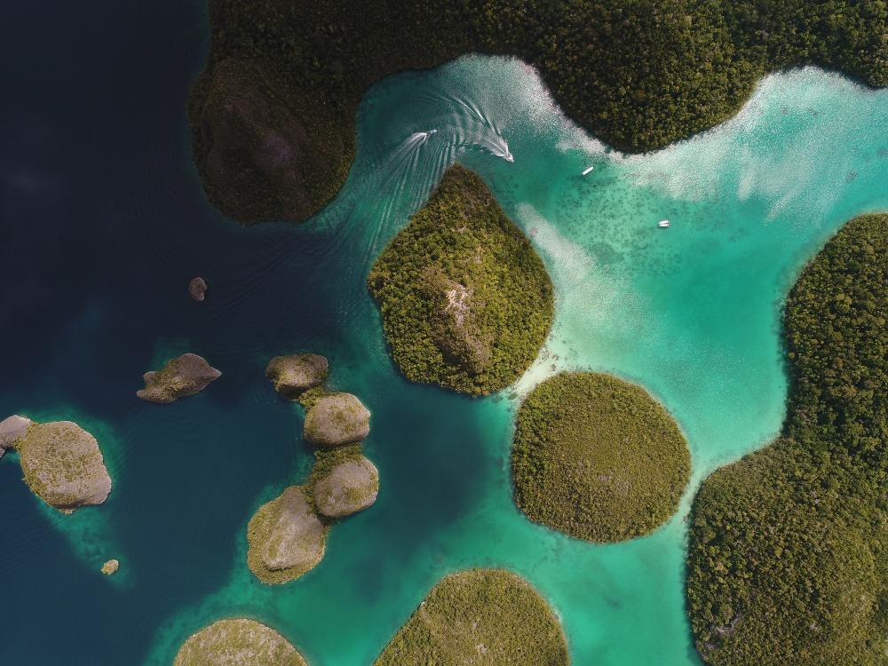 Aerial shot of El Nido's Big Lagoon at low tide with limestone cliffs under clear sky