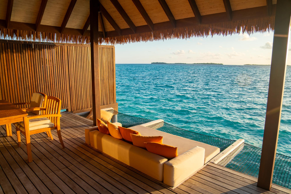 Maldives in May Overwater bungalow in Maldives with turquoise lagoon and sunset