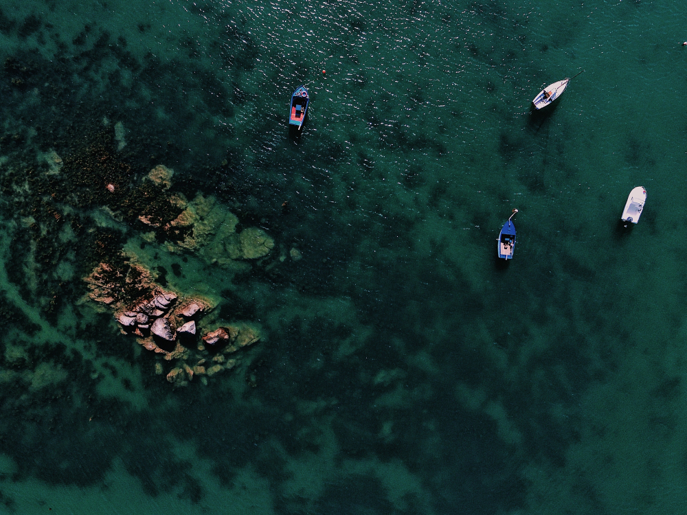 Aerial view of Big Lagoon, Tour A, with limestone cliffs enclosing turquoise water and outrigger boats