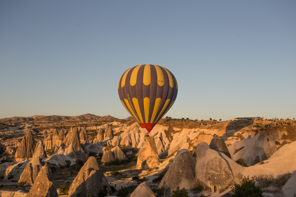 Hot air balloons flying over Cappadocia's fairy chimneys in Turkey