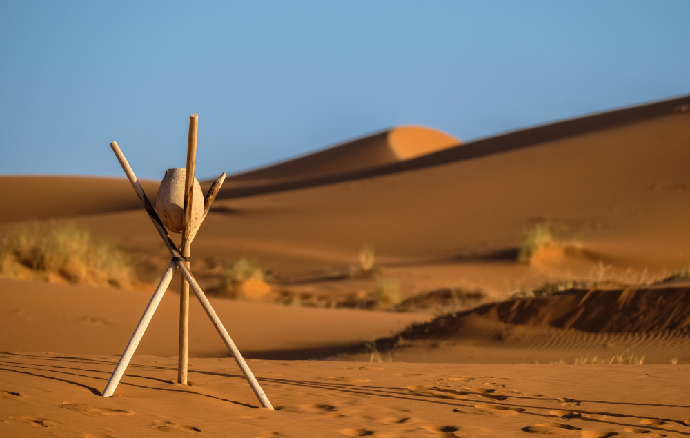 Morocco in July Camel trek in Sahara desert dunes at sunset