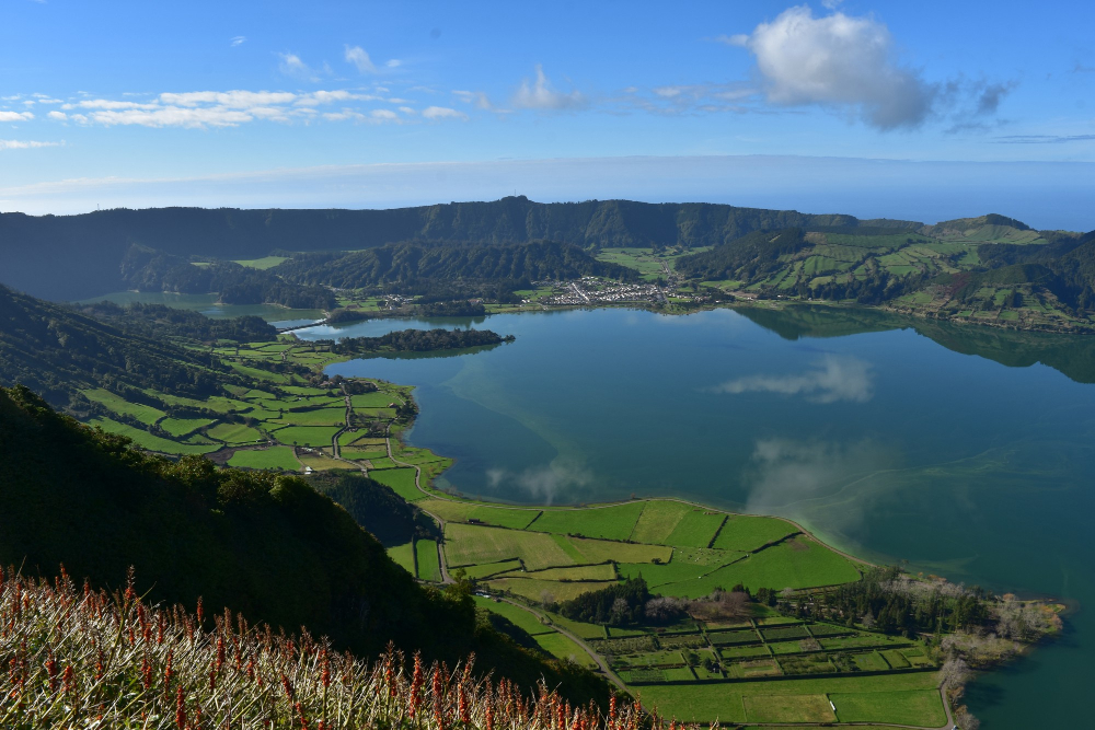 Azores in July Green volcanic crater lake in Azores with blue sky