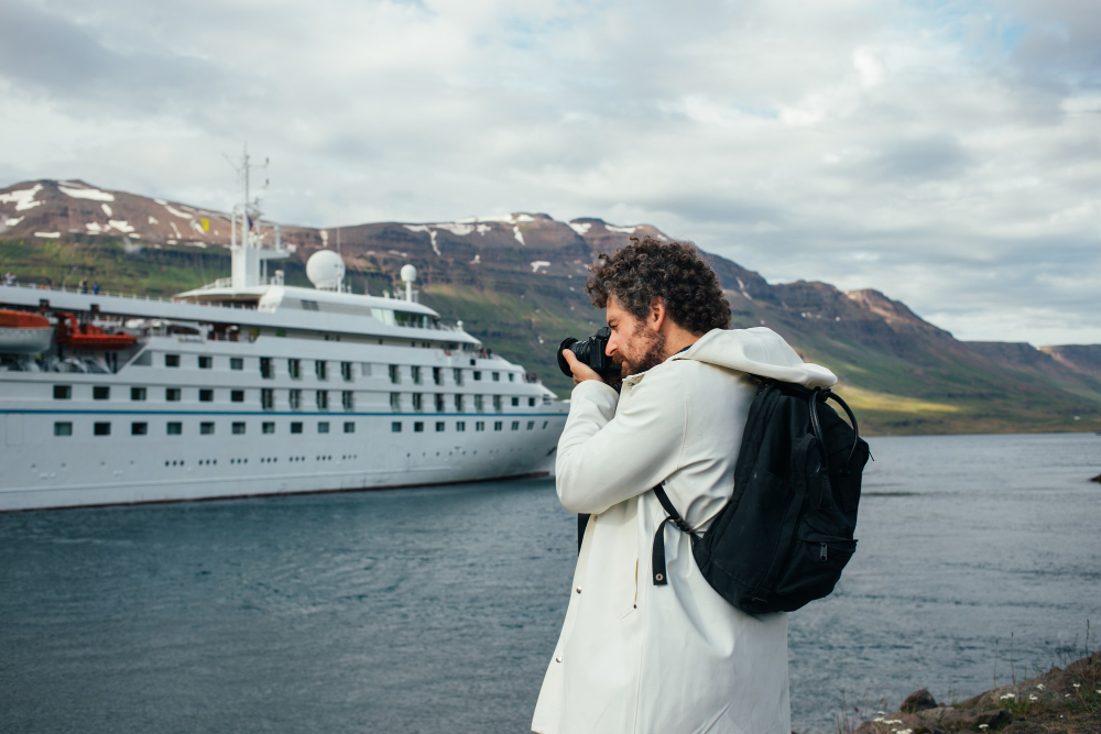 Iceberg and cruise ship in Greenland fjord