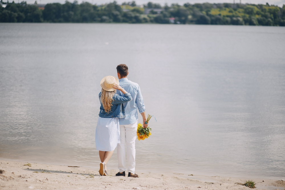 Romantic couple dining on a beach at sunset